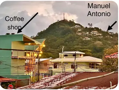 a view of a building with a mountain in the background at Kens Lower department in Quepos