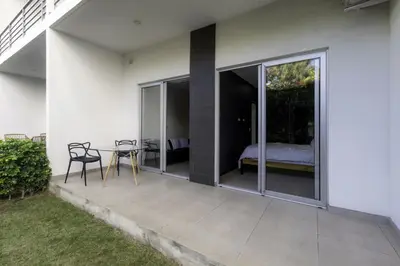 a patio with a table and chairs and a bed at Corporate Stays Urban Flats 1 Bedroom in San Rafael