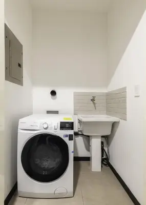 a washing machine in a bathroom with a sink at Corporate Stays Urban Flats 1 Bedroom in San Rafael