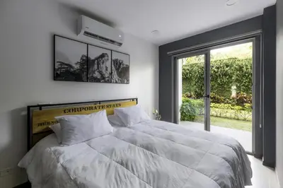 a bedroom with a large bed and a large window at Corporate Stays Urban Flats 1 Bedroom in San Rafael
