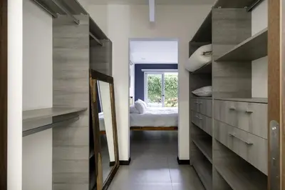 a hallway with wooden cabinets and a bed in a room at Corporate Stays Urban Flats 1 Bedroom in San Rafael