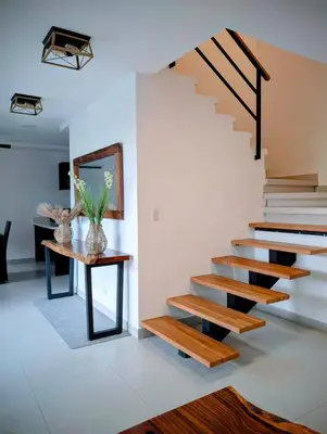 a staircase in a house with a table at Casa PAMPA in Liberia