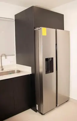 a stainless steel refrigerator in a kitchen with a sink at Casa PAMPA in Liberia