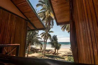 a room with a view of the beach and the ocean at Poolside Unit at Beachfront Hotel in Sámara