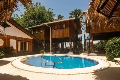 a swimming pool in front of a house at Poolside Unit at Beachfront Hotel Unit 6 in Sámara