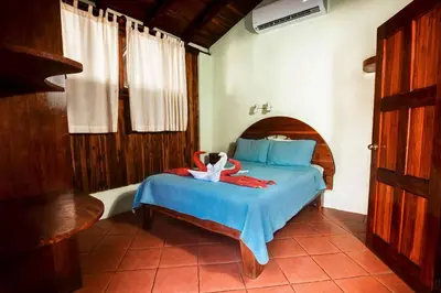 a bedroom with a bed with a swan on it at Poolside Unit at Beachfront Hotel Unit 6 in Sámara