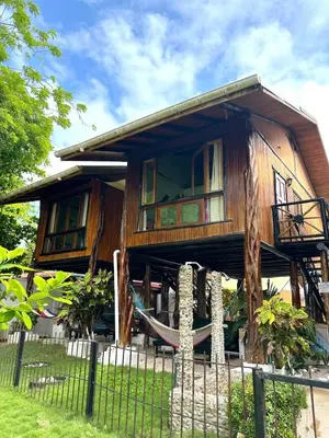a tree house with a hammock in front of it at Tree House Inn Ocean Front Unit #2 in Sámara