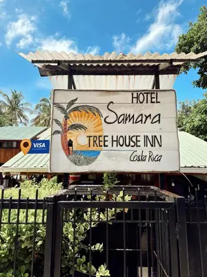 a sign for a hotel samana tree house inn at Tree House Inn Ocean Front Unit #2 in Sámara