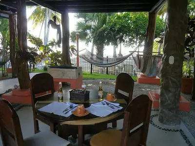 a table with napkins and drinks on top at Tree House Inn Ocean Front Unit #2 in Sámara