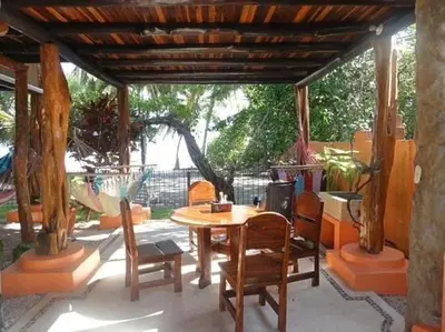 a wooden table and chairs on a patio at Samara Treehouse Inn Unit 3 in Sámara