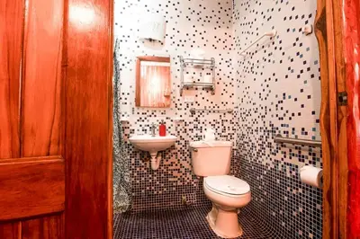 a bathroom with a toilet and a sink at Samara Treehouse Inn Unit 3 in Sámara