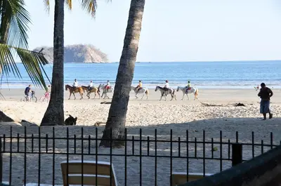 a group of people riding horses on the beach at Samara Tree House Inn Unit 4 in Sámara