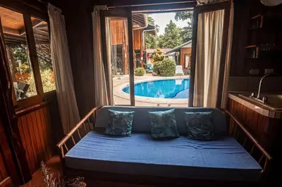 a couch in a room with a view of a pool at Samara Tree House Inn Unit 4 in Sámara