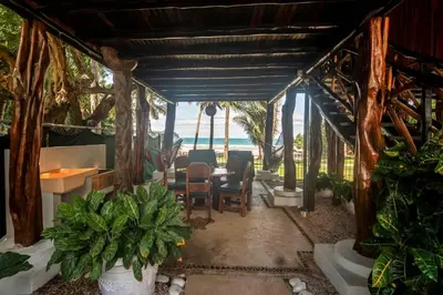 a dining room with a table and a view of the ocean at Treehouse Inn on the Beach in Sámara