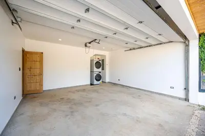an empty garage with a washer and dryer at Casa Peace with salt water pool 4BR 4BR in Tamarindo