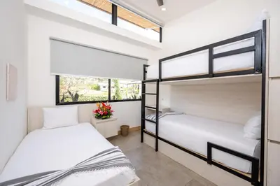 two bunk beds in a room with windows at Casa Peace with salt water pool 4BR 4BR in Tamarindo