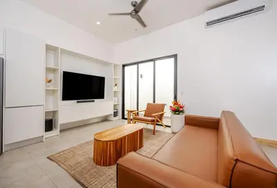 a living room with a couch and a tv at Casa Peace with salt water pool 4BR 4BR in Tamarindo