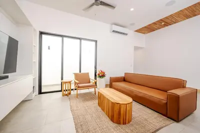 a living room with a couch and a tv at Casa Peace with salt water pool 4BR 4BR in Tamarindo