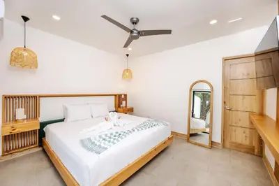 a bedroom with a bed and a mirror at Casa Peace with salt water pool 4BR 4BR in Tamarindo
