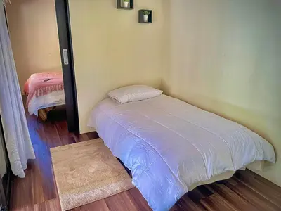 a small bedroom with a bed in a room at M&M Container Home in Sardinal
