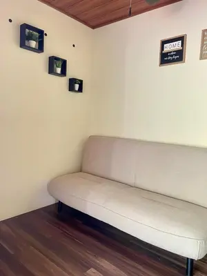 a couch in a room with pictures on the wall at M&M Container Home in Sardinal
