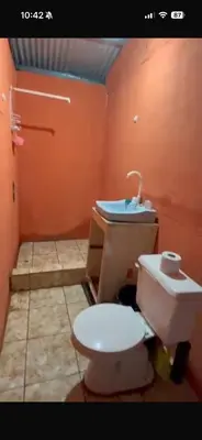 a bathroom with a toilet and a sink at Camping y hospedaje playa azul in Tarcoles
