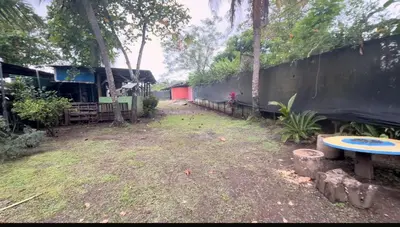an empty yard with a bench and a fence at Camping y hospedaje playa azul in Tarcoles