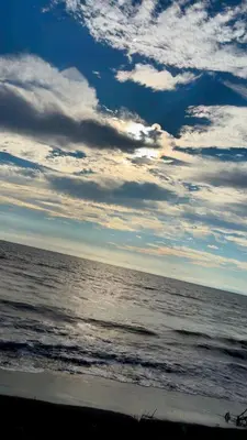 a view of the ocean under a cloudy sky at Camping y hospedaje playa azul in Tarcoles