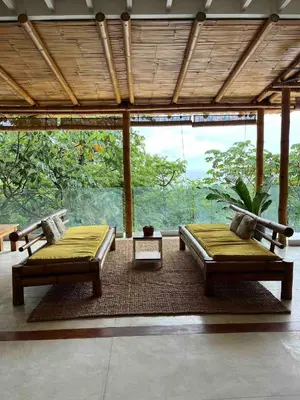 a room with two beds and a large window at Ocean view Jungle Nest - 2min from the beach in Santa Teresa Beach