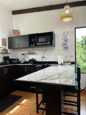 a kitchen with a table with a counter top at Apartamento Villas Luna in Potrero