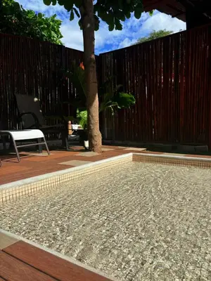 a swimming pool with a fence and a tree at Apartamento Villas Luna in Potrero