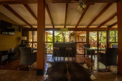 a screened in porch with chairs and a table at Rancho Humo Estancia in Puerto Humo