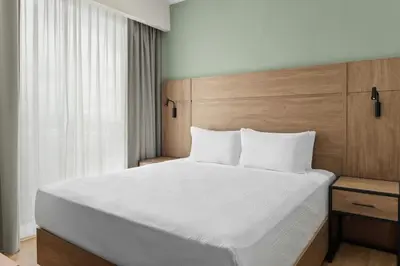 a bedroom with a large white bed and a window at Residence Inn by Marriott San Jose Alajuela el Coyol in San José