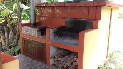 a outdoor brick oven with a fire inside at CASA QUEPOS- Private House & Farm For 8-31 Guests in Quepos