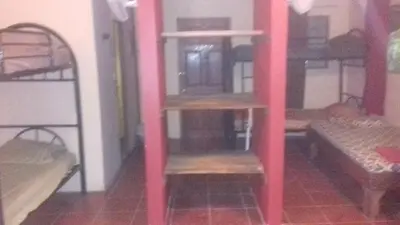 a room with two bunk beds and a room with two benches at CASA QUEPOS- Private House & Farm For 8-31 Guests in Quepos