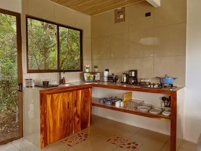 a kitchen with a counter and a window at Cabaña Elvira in La Cruz
