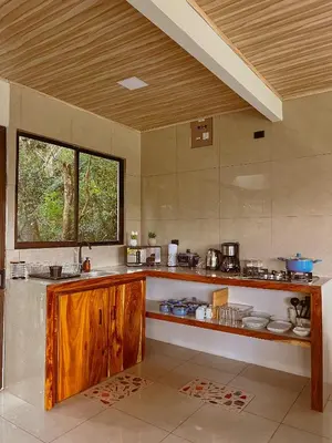 a large kitchen with a counter and a window at Cabaña Elvira in La Cruz