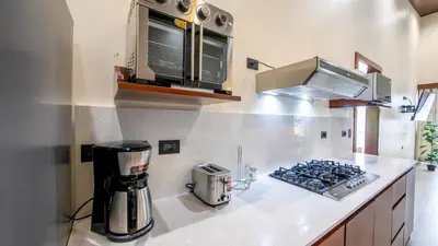 a kitchen with a counter with a stove top oven at Villa Alma Verde in Fortuna