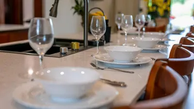 a table with wine glasses and plates on it at Villa Alma Verde in Fortuna