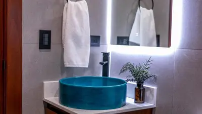 a bathroom with a blue sink and a mirror at Villa Alma Verde in Fortuna