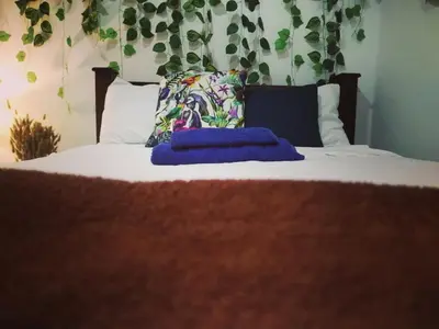 a bed with two pillows on top of it at Habitaciones Smith in San José
