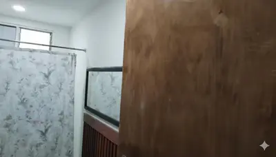 a bathroom with a shower curtain and a window at Habitaciones Smith in San José