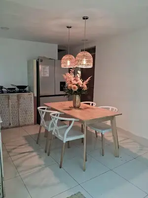 a table and chairs with a vase of flowers on it at Habitaciones Smith in San José