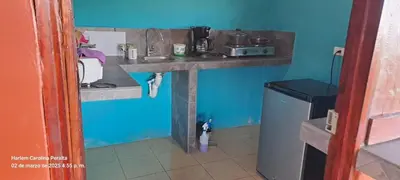 a kitchen with a sink and a blue wall at cabaña Carol in Rio Celeste