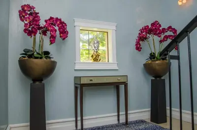 two vases with flowers in them on a stair case at Casa Serena Luxury Retreat in Reserva Conchal in Brasilito