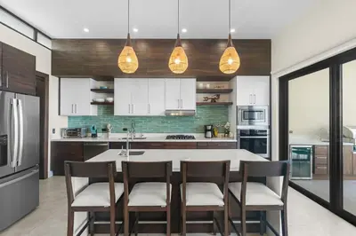 a kitchen with a table and chairs and a refrigerator at Luxury Ocean View Villa in Playa Hermosa