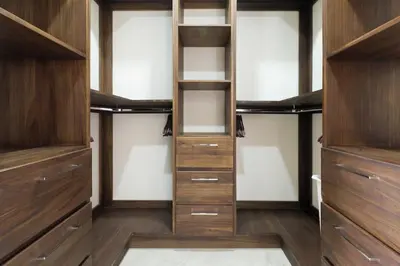 a walk in closet with wooden cabinets and shelves at Luxury Ocean View Villa in Playa Hermosa