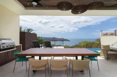 a dining room with a large table and chairs at Luxury Ocean View Villa in Playa Hermosa