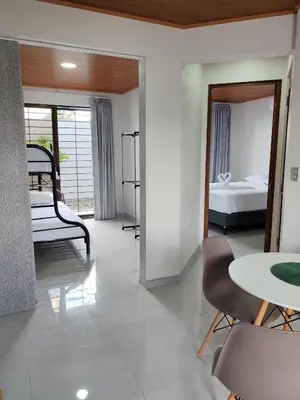 a living room with a bed and a table and chairs at Fortuna River Way Apartments in Fortuna