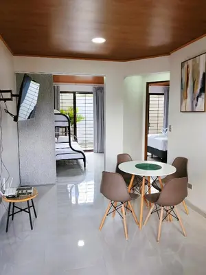 a living room with a table and chairs and a bedroom at Fortuna River Way Apartments in Fortuna